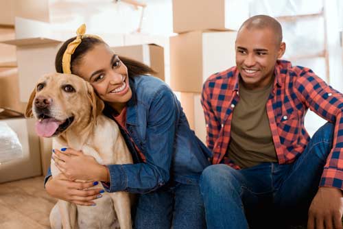 couple and dog in new home