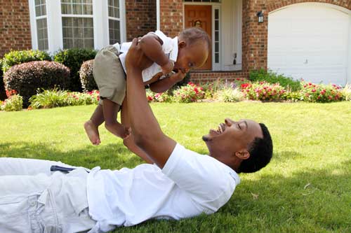 father and son playing in yard